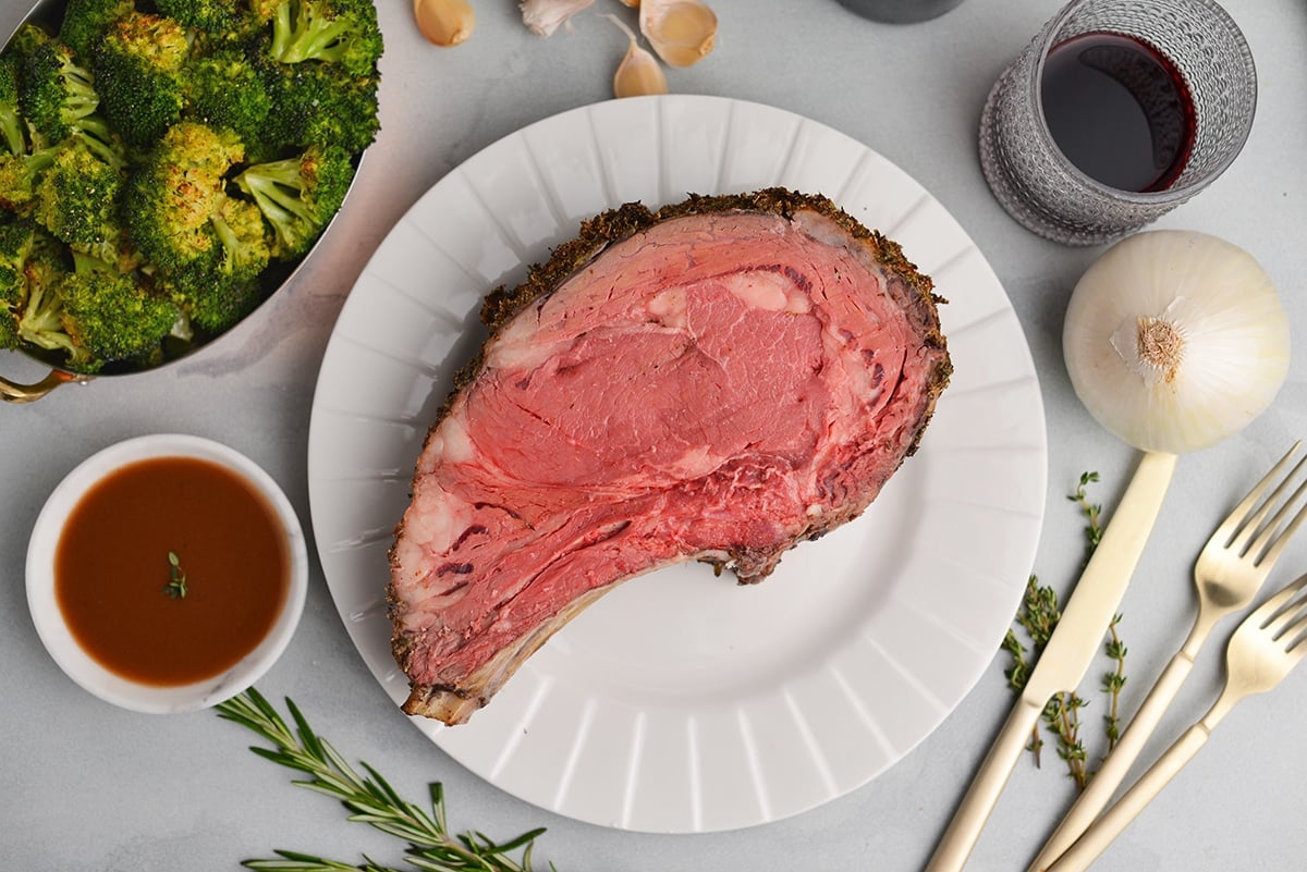 rare king cut of prime rib on a white plate