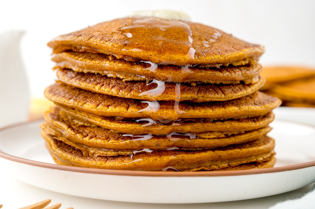 head-on view of pancakes with syrup dripped down the side
