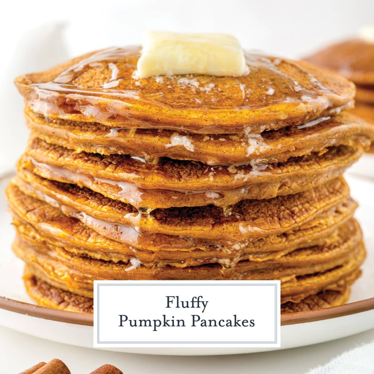 straight on shot of stack of pumpkin spice pancakes topped with butter and syrup