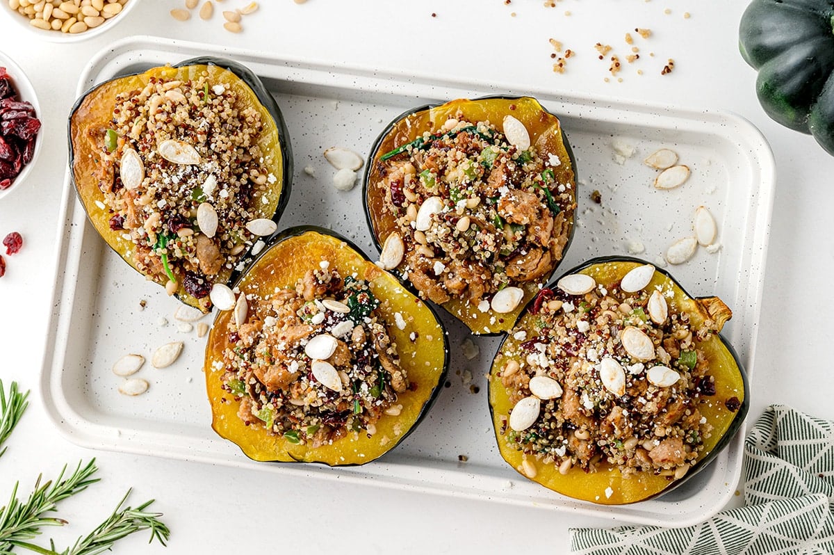 4 halves of stuffed acorn squash on a baking sheet