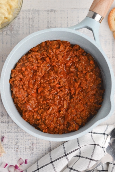 overhead of hot meat sauce in a blue saucepan
