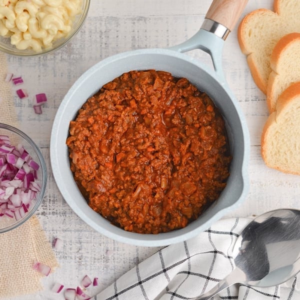 overhead of hot meat sauce in a blue saucepan