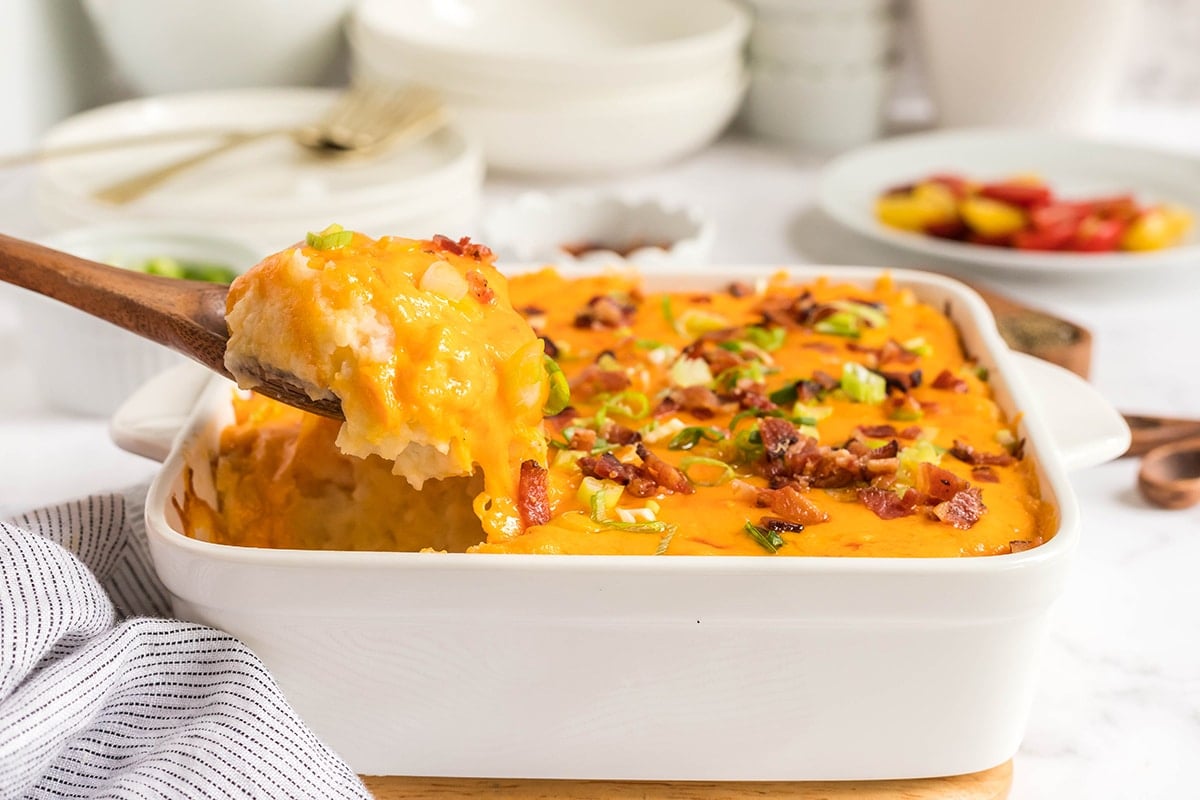 spoon in dish of twice baked potato casserole