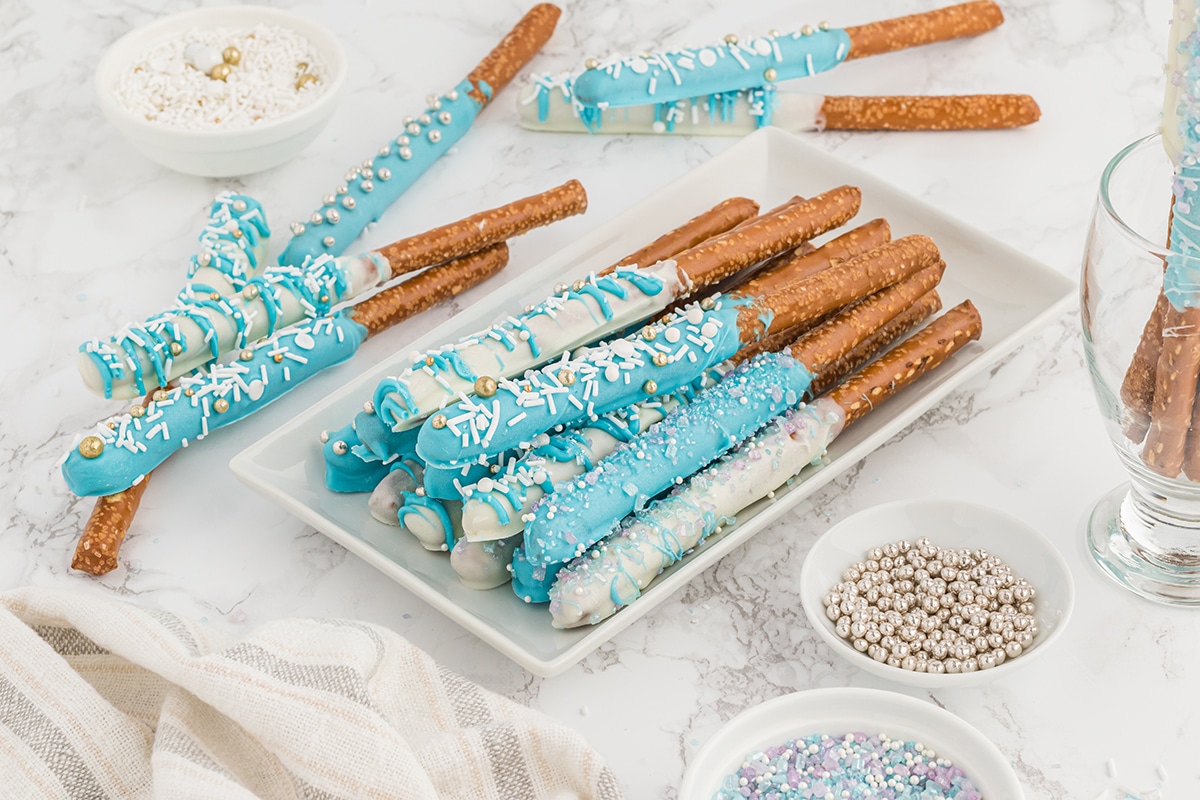 chocolate covered pretzel rods stacked on a plate