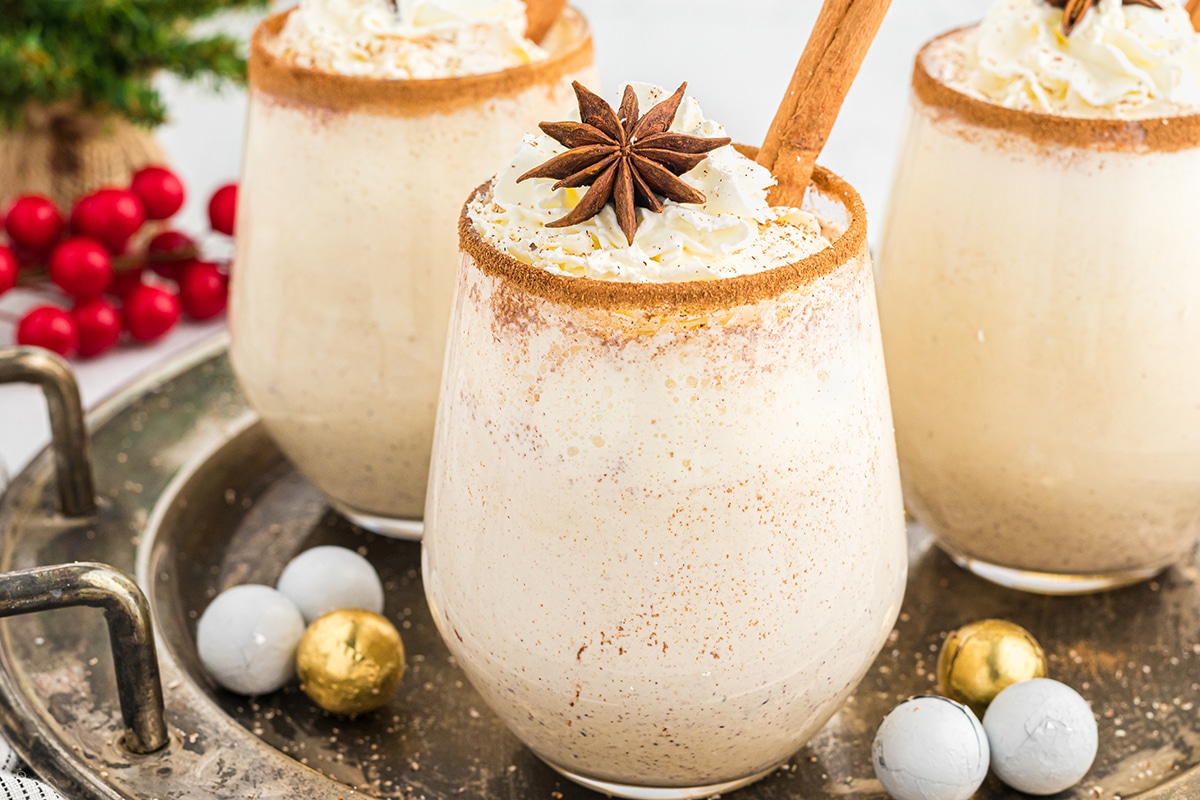 three glasses of homemade eggnog on a tray