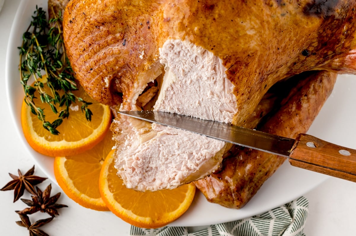 knife slicing orange thyme turkey