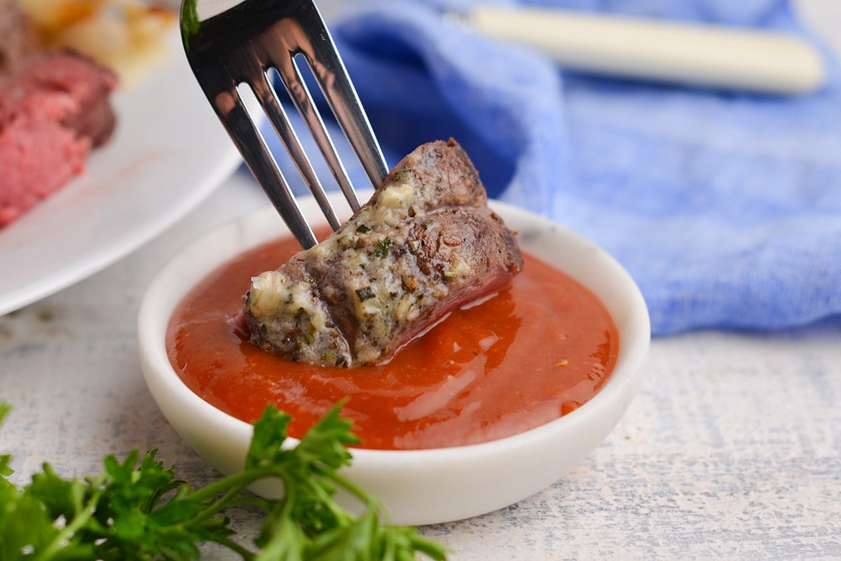 steak dipping into homemade sauce