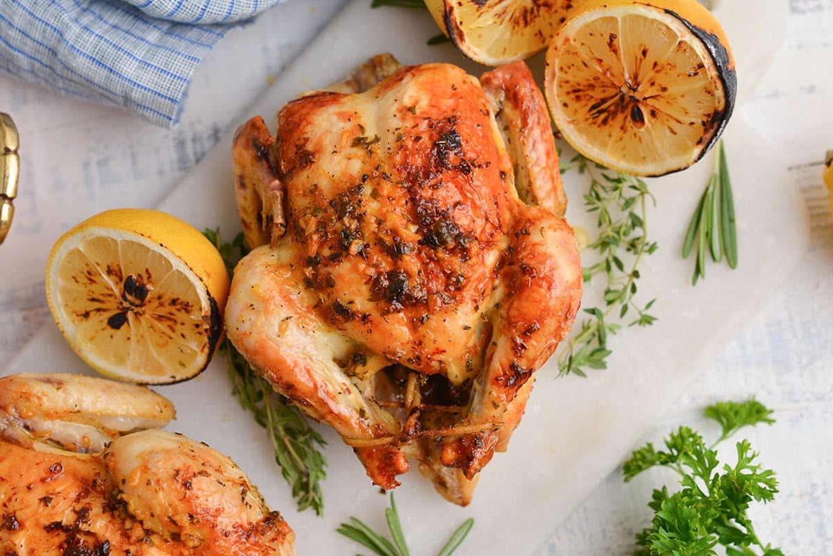 close up of herb garlic butter on a game hen