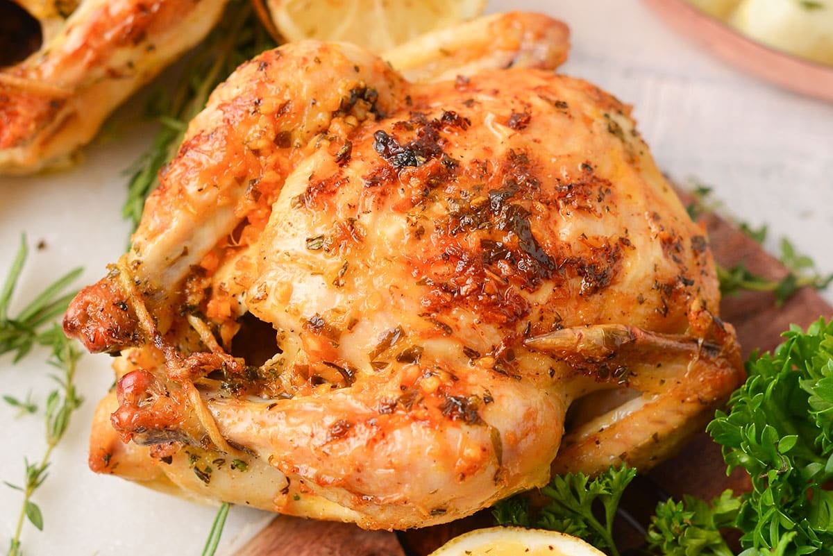 close up of butter cornish hen on a serving platter