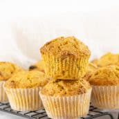 two muffins stacked on a cooling rack