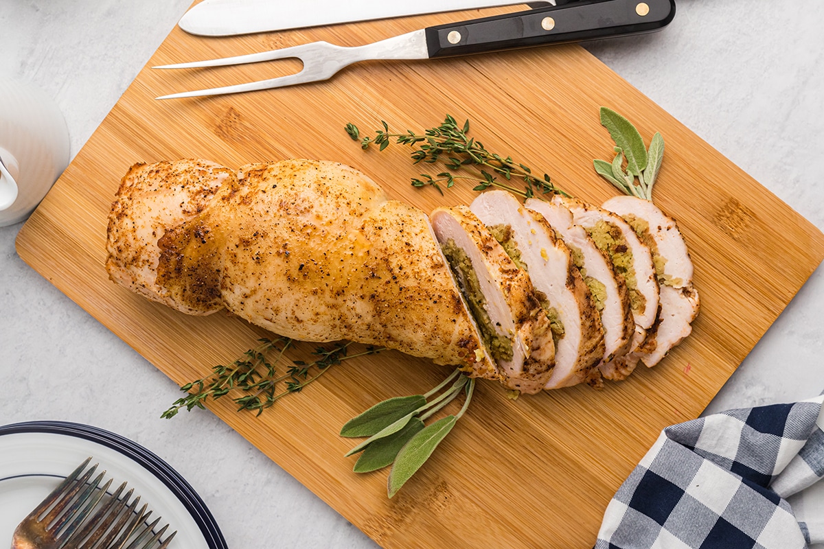 stuffed turkey breast sliced on a cutting board