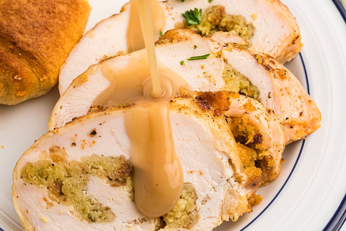 gravy pouring onto sliced turkey breast