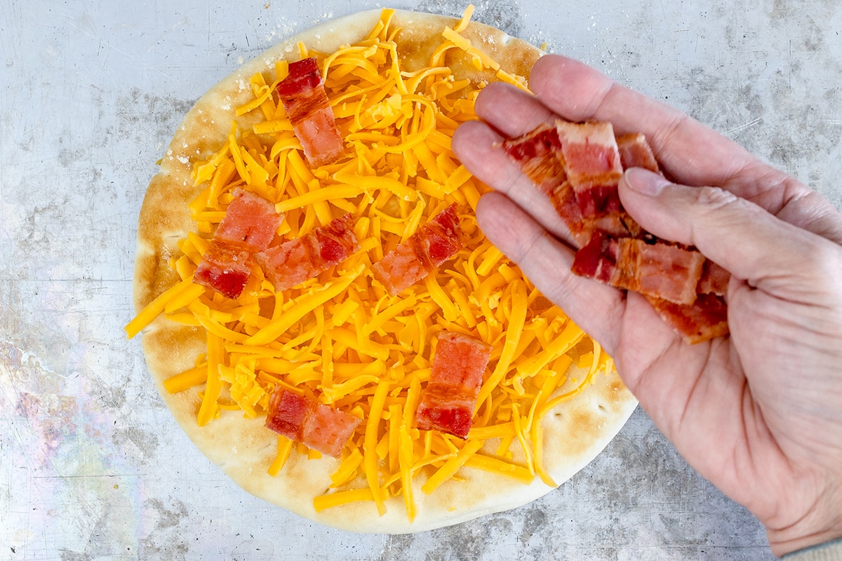 bacon sprinkled onto flatbread