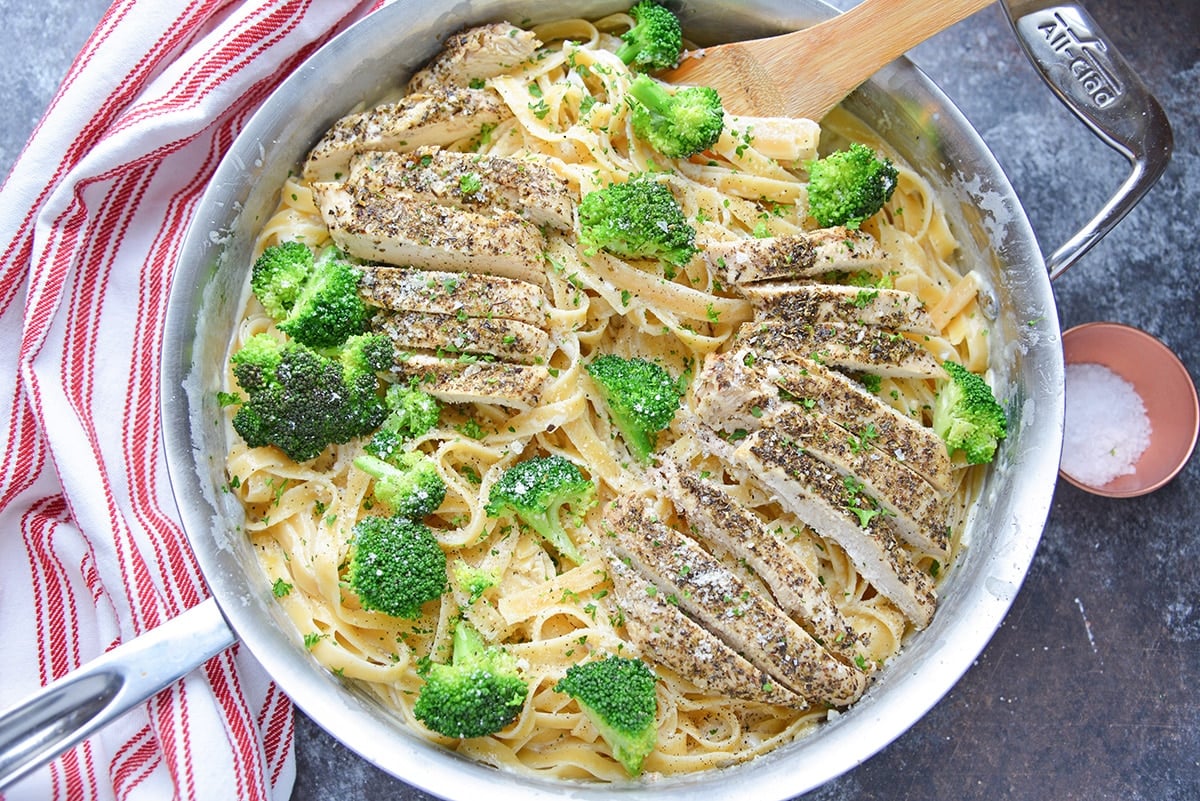 overhead of broccoli chicken alfredo in a skillet