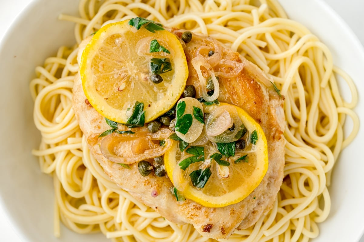 close up of piccata on spaghetti