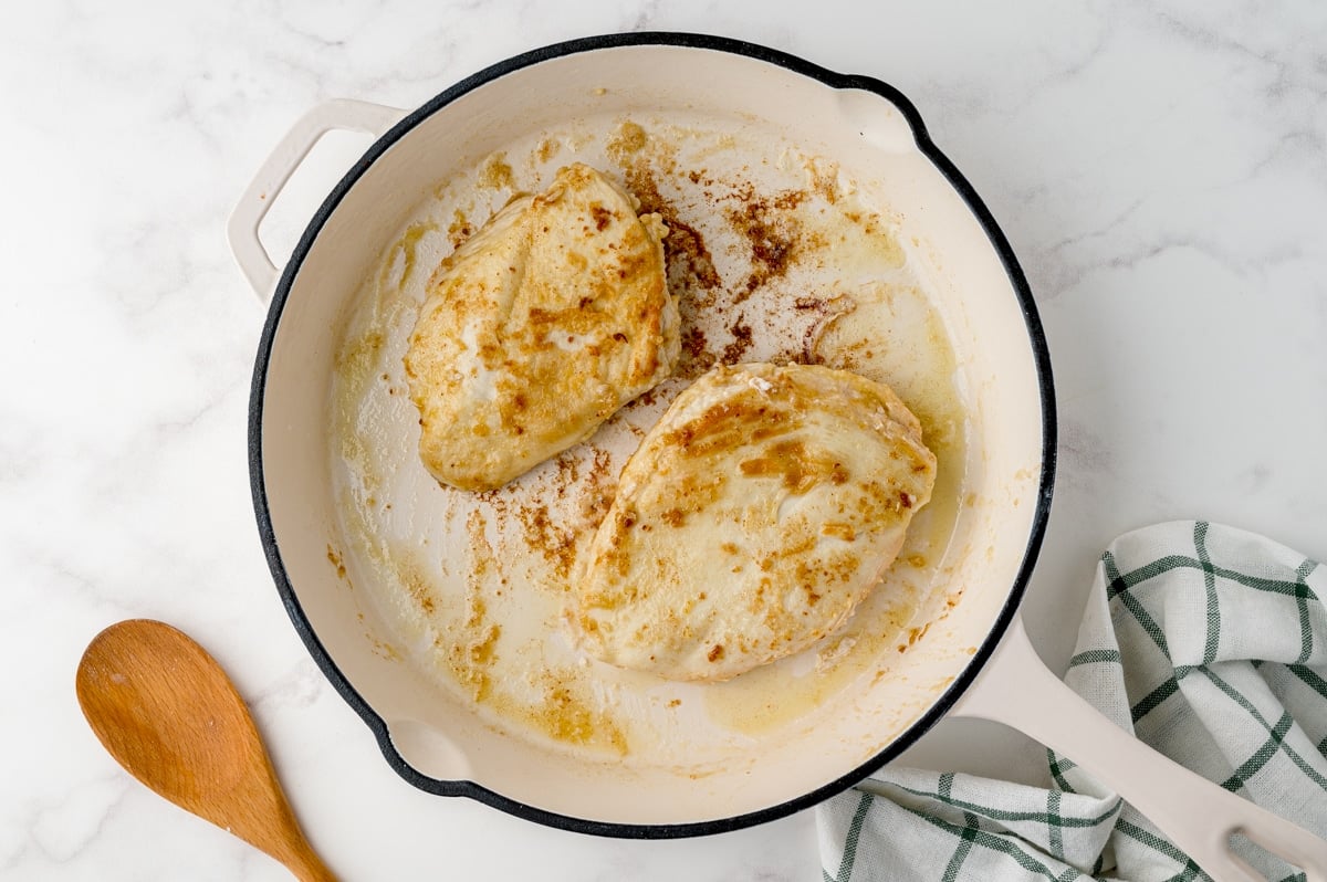 browned chicken in a frying pan