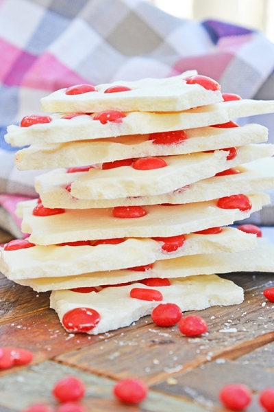 stack of cinnamon bark with red hot candies