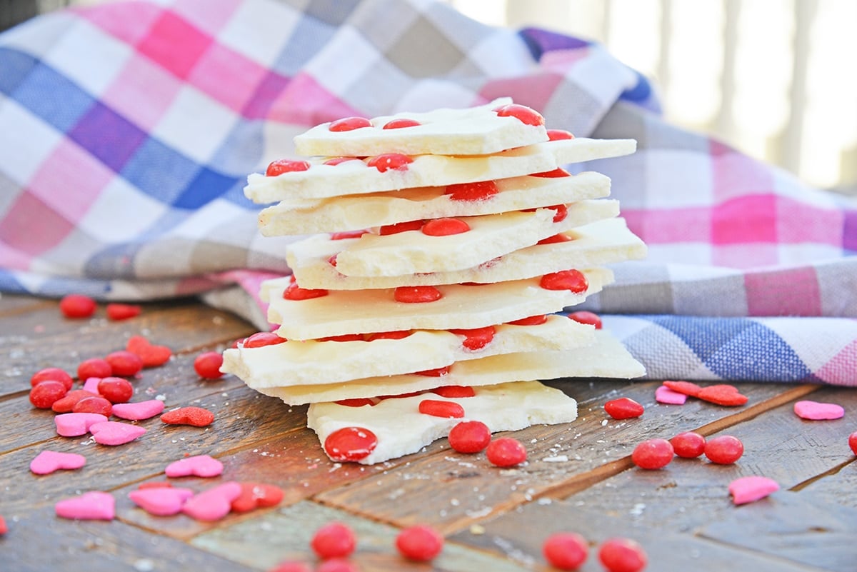 stack of cinnamon bark with red hot candies