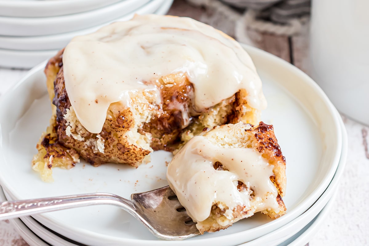 fork with bite of cinnamon roll