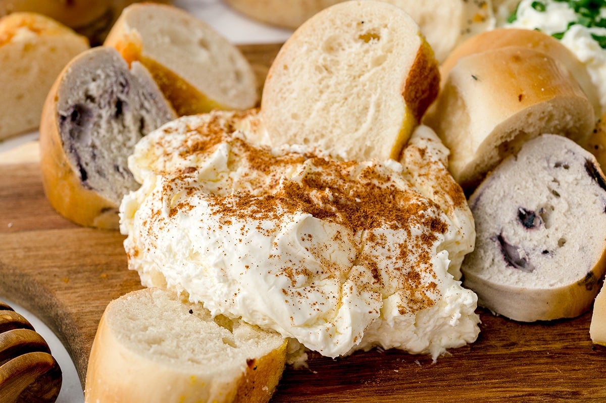 bagel dipping into cinnamon cream cheese