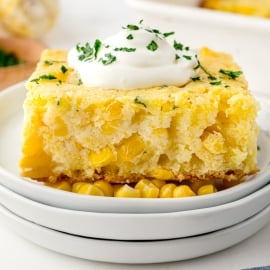 straight on shot of creamed corn casserole topped with sour cream