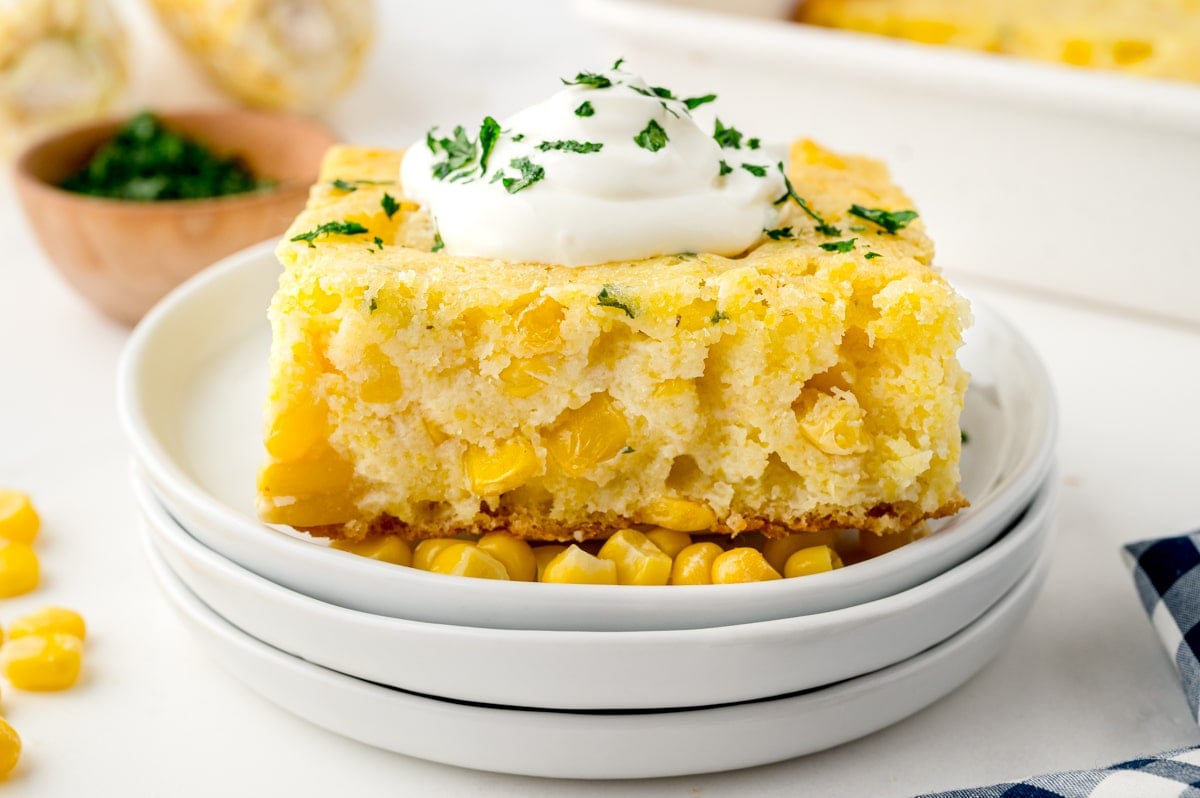 straight on shot of creamed corn casserole topped with sour cream