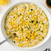 home style creamed corn in a bowl with parsley garnish