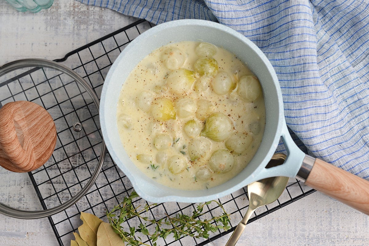 overhead shot of creamed onions in a pot