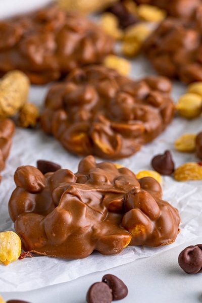 close up of peanut clusters on parchment paper