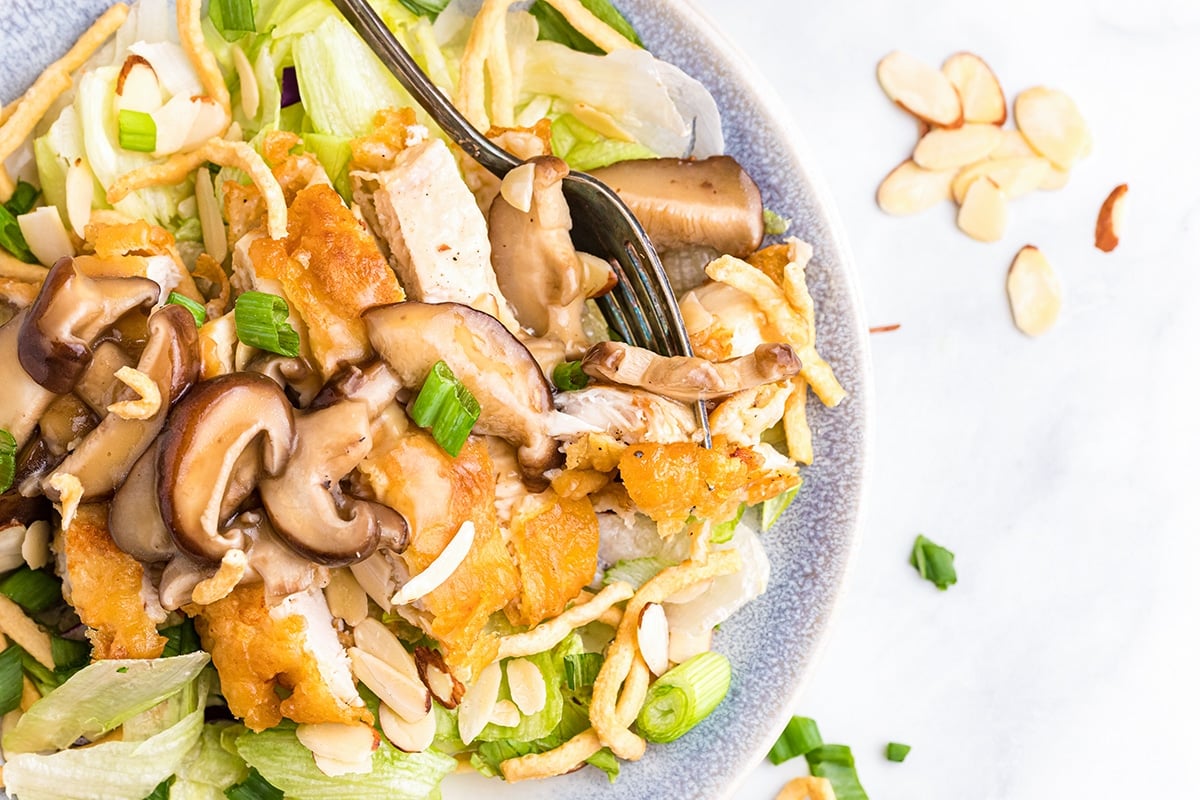 fork digging into chinese almond chicken