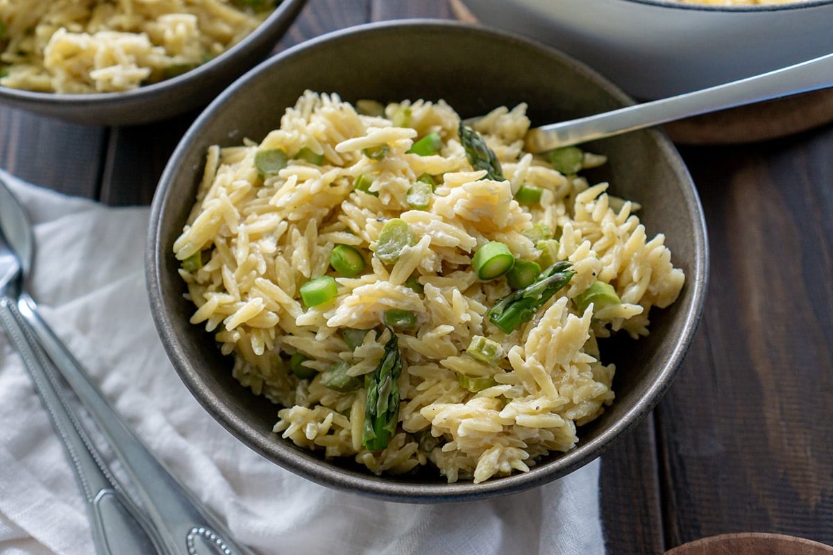 angled shot of bowl of orzo salad