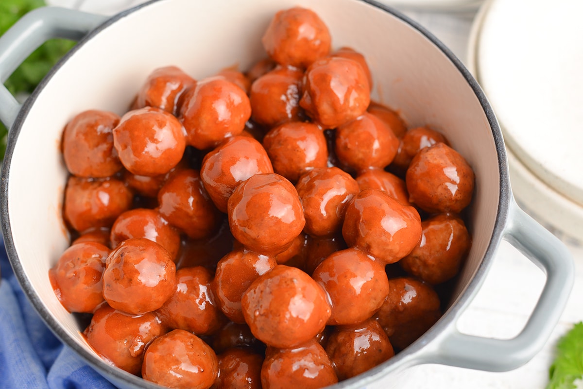 angle close up of grape jelly meatballs in a pot