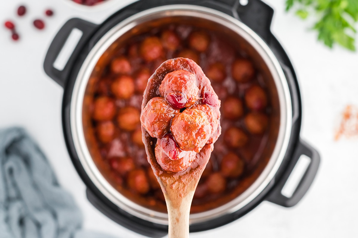 wooden spoon with cranberry meatballs