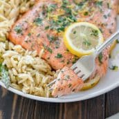 fork holding a bite of lemon pepper salmon