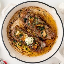 overhead of two steaks in a pan