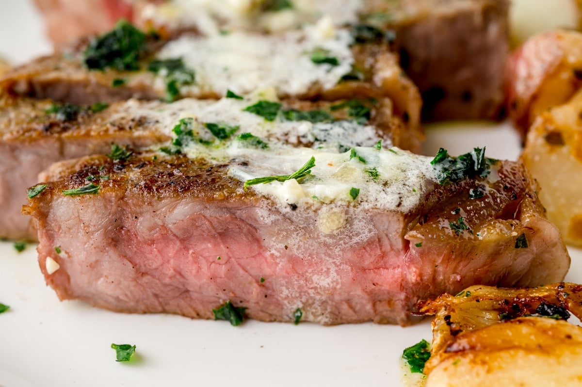 slice of medium rare steak with butter