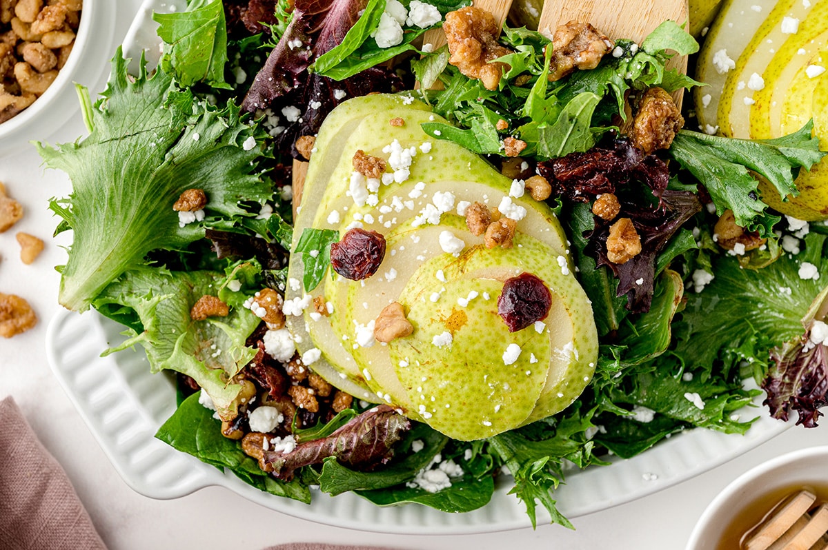 sliced pear over greens with walnuts