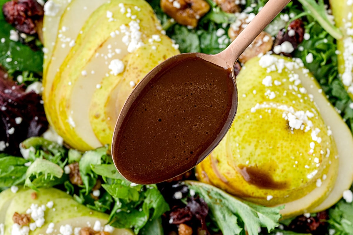 dressing spooned over pear salad