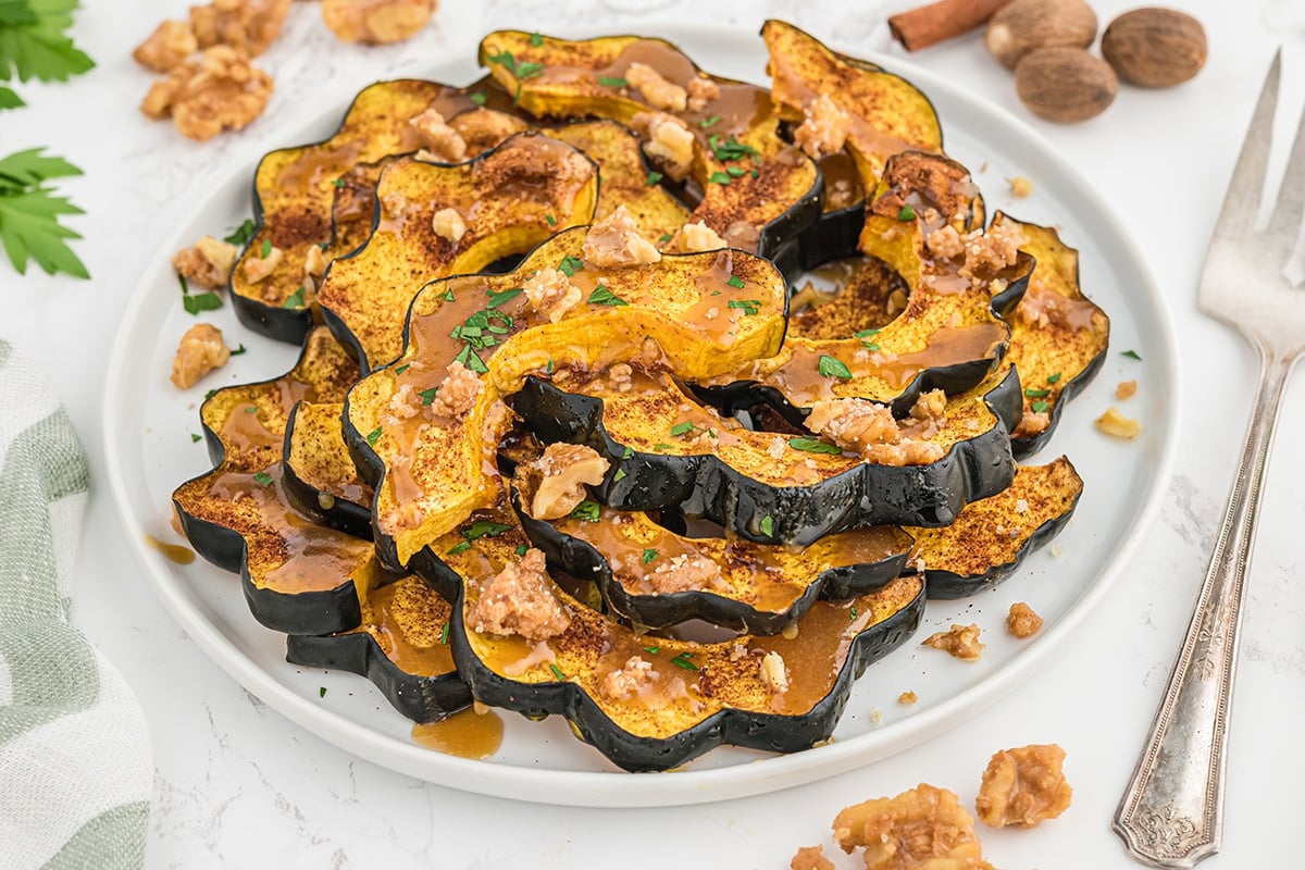 angle serving platter of squash slices with sauce and nuts