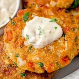 salmon pattie with white creamy sauce on top