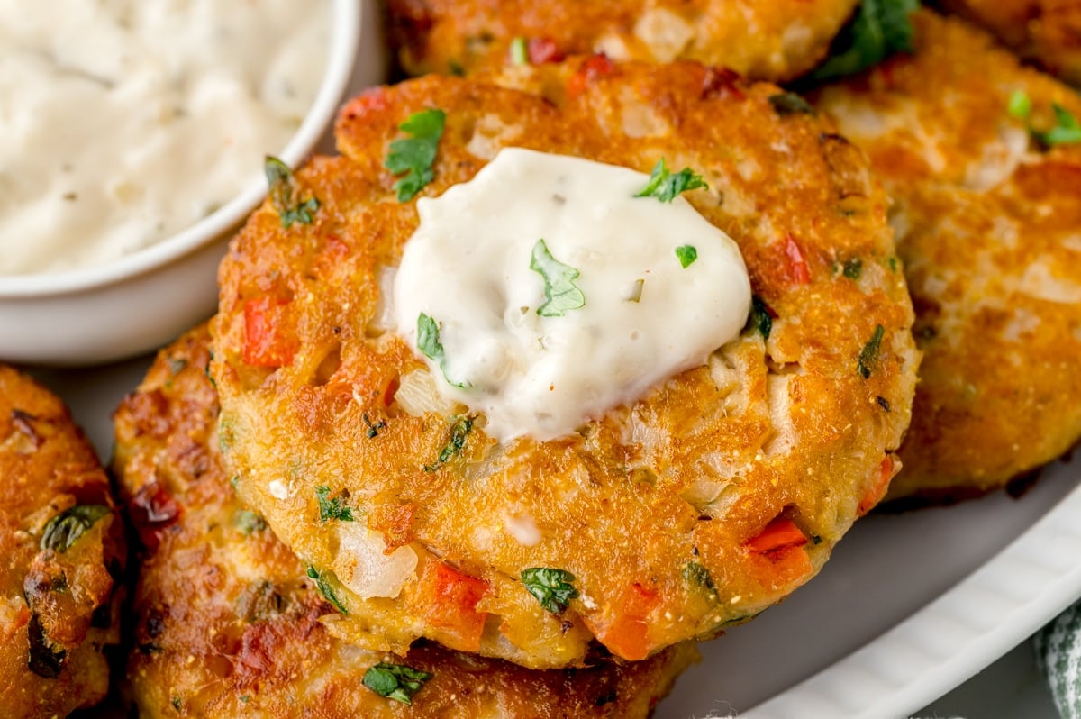 salmon pattie with white creamy sauce on top