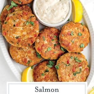 overhead of salmon croquettes on a serving platter with sauce