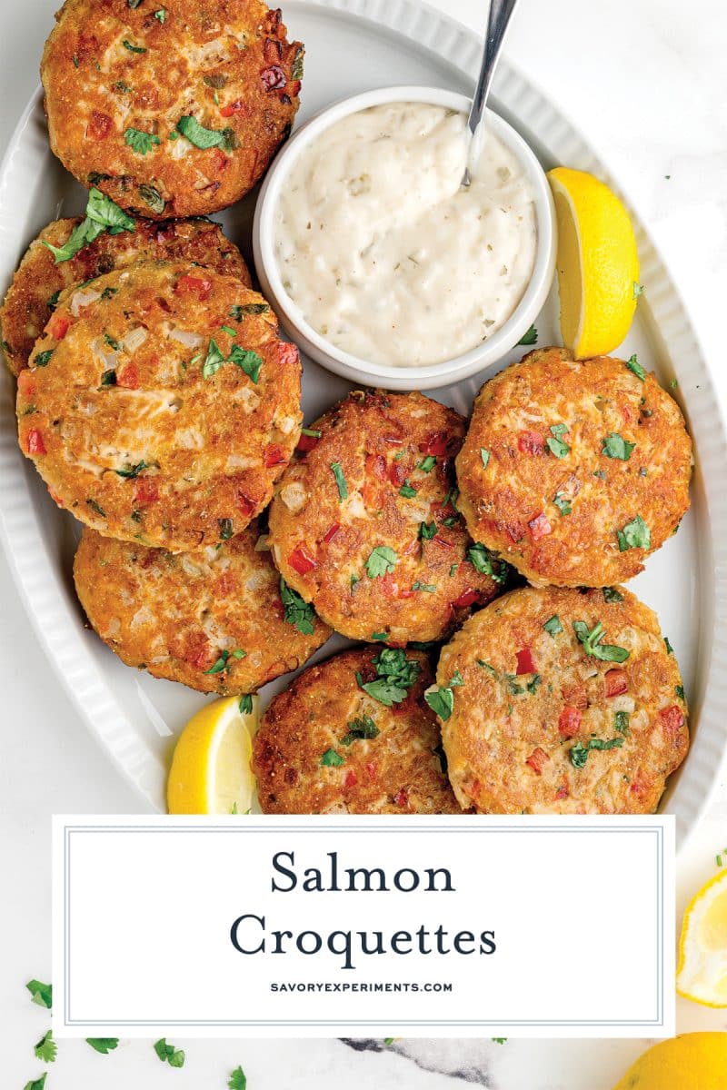 overhead of salmon croquettes on a serving platter with sauce