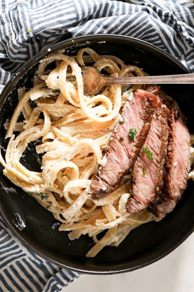 overhead of steak alfredo in a bowl