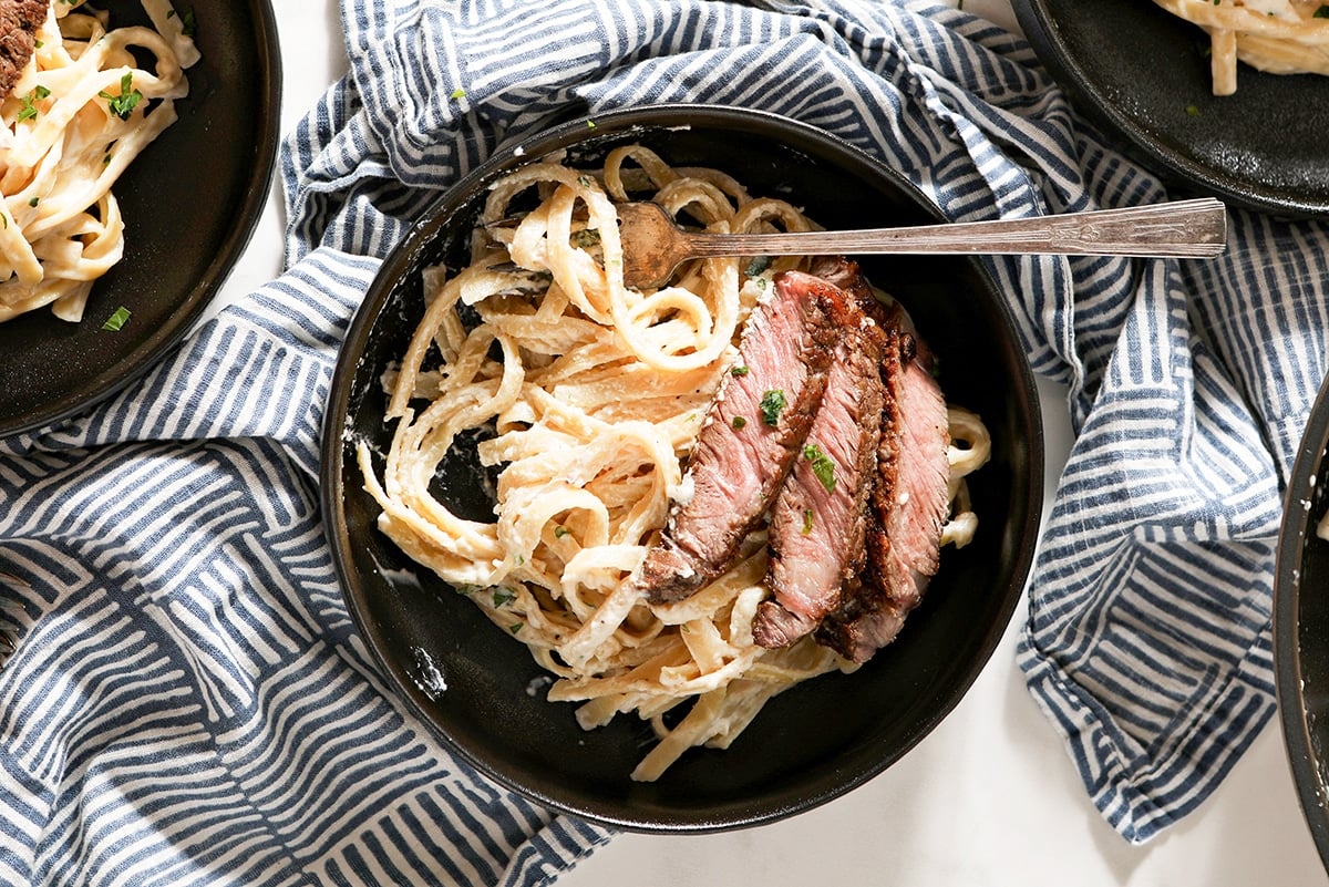 overhead of steak alfredo in a bowl