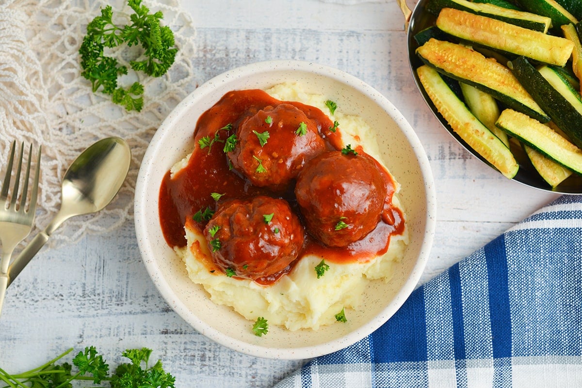 BBQ meatballs over a pile of mashed potatoes
