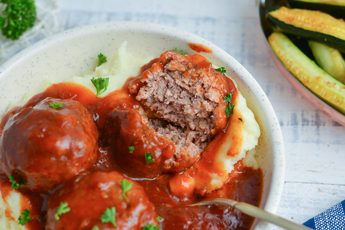 meatball cut in half in bbq sauce