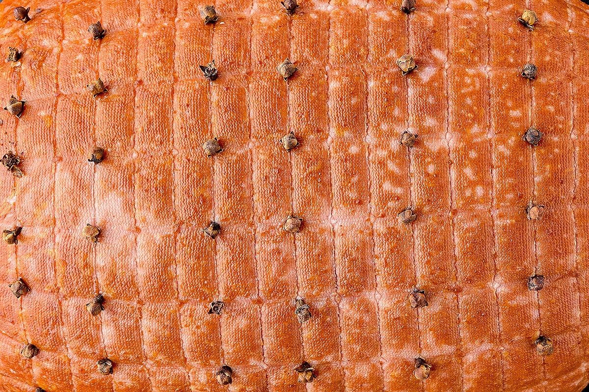 close up of cloves in a boneless ham roast