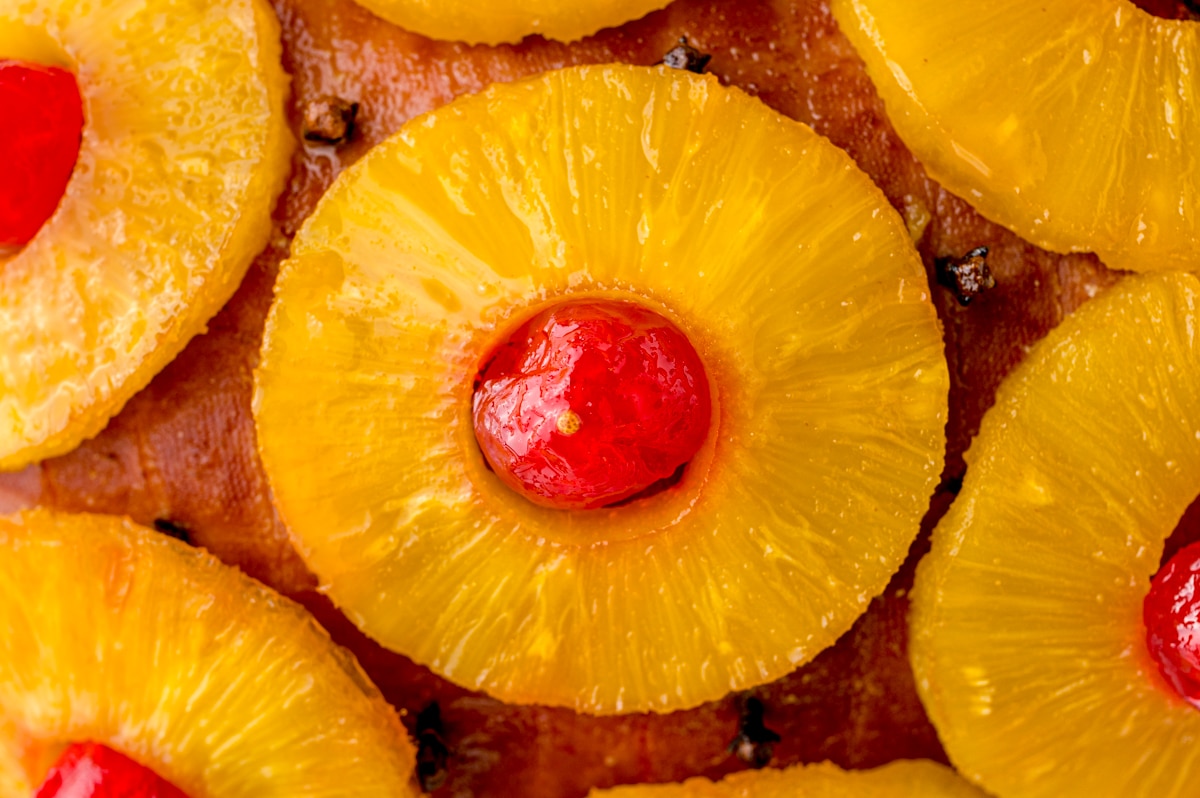 close up of a pineapple slice with a cherry