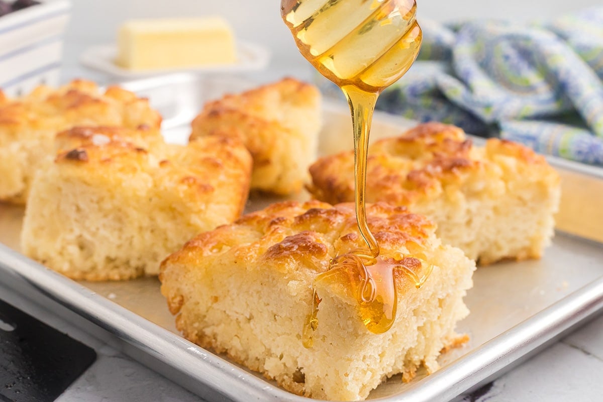 honey drizzling over butter swim biscuits